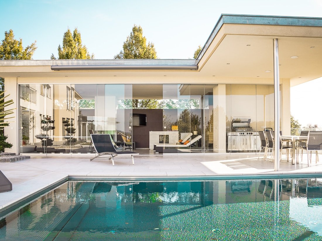 Modern Ottawa outdoor living renovation with pool and screened pavilion