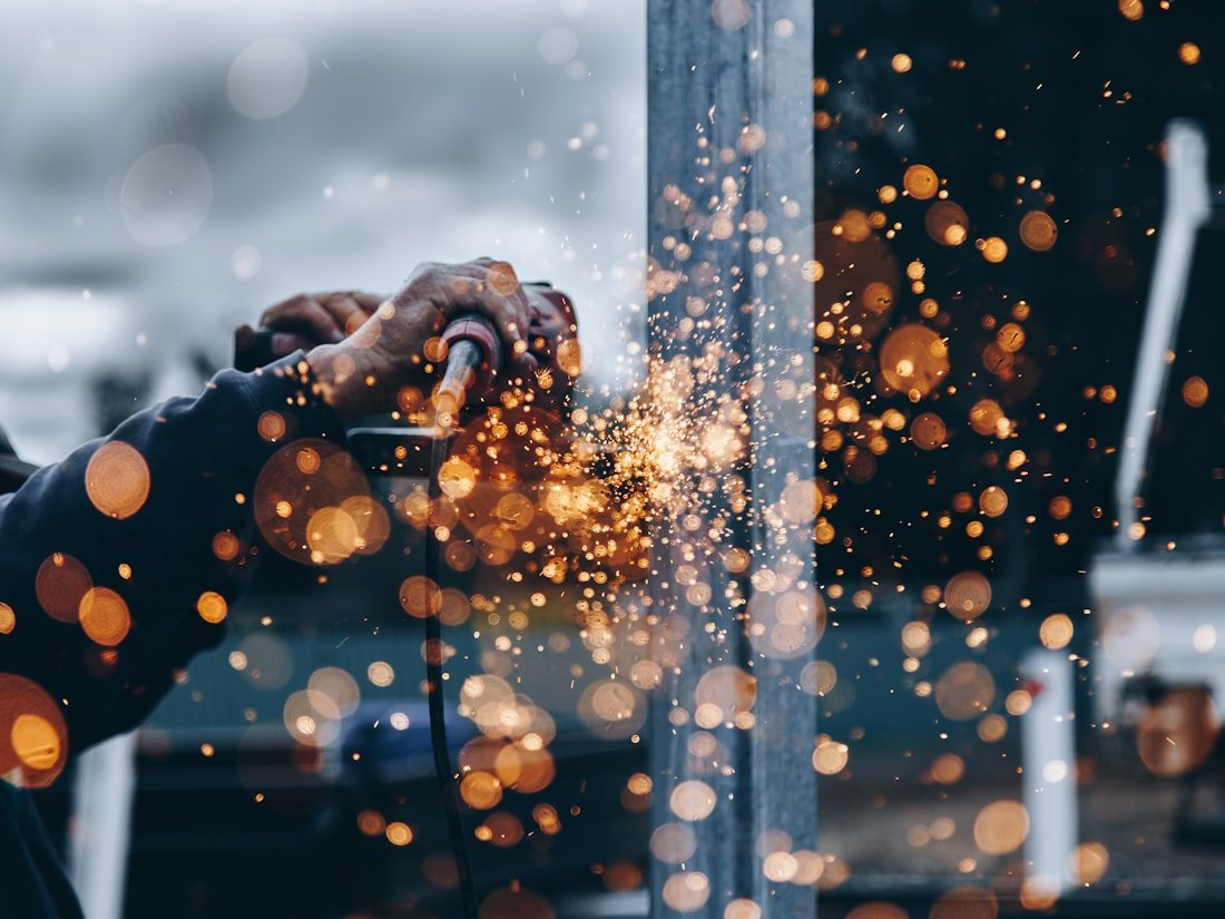 In-house Ottawa fabrication shop crew working metal with sparks